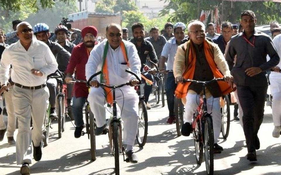 Haryana CM Khattar travels by train to Karnal, then rides bicycle to cast his vote