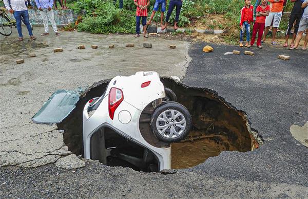 Delhi traffic cop’s car sinks completely in Dwarka after road caves in following heavy rains