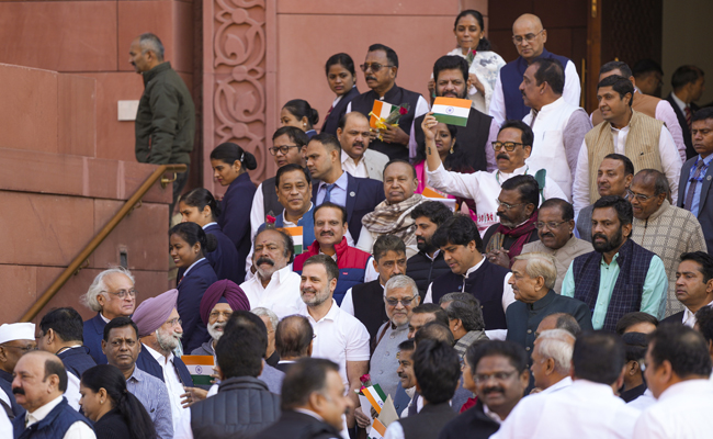 Small tricolour, red rose in hand, Opposition MPs urge govt to run House