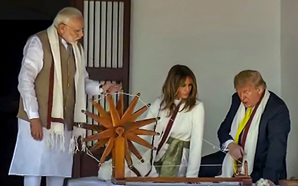 Trump, wife try spinning ''charkha'' at Sabarmati Ashram
