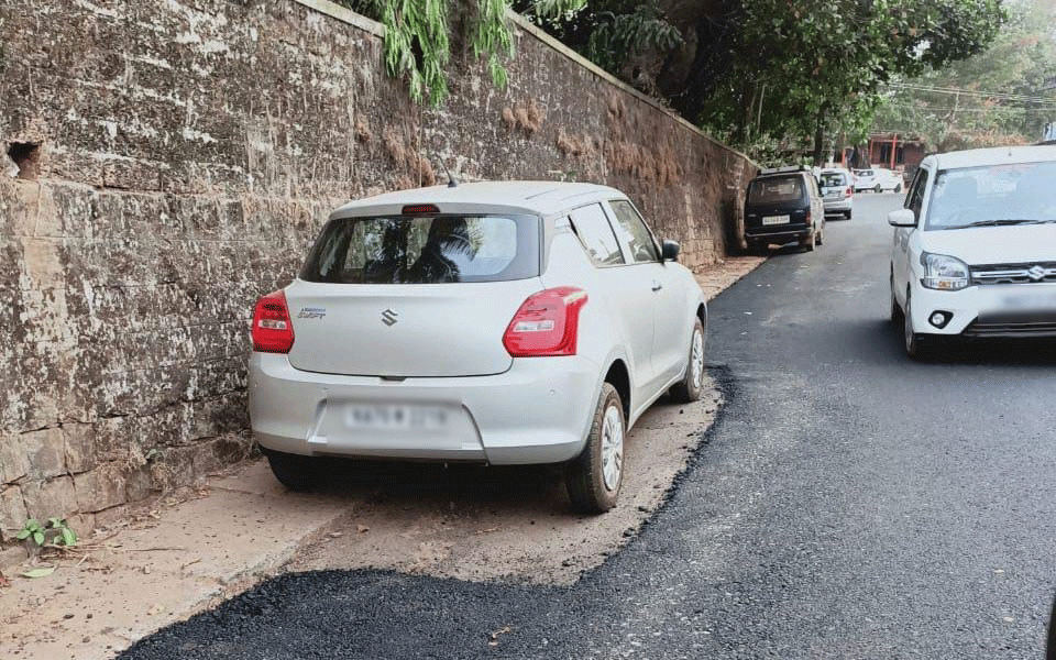 Asphalting of road done excluding parked car area