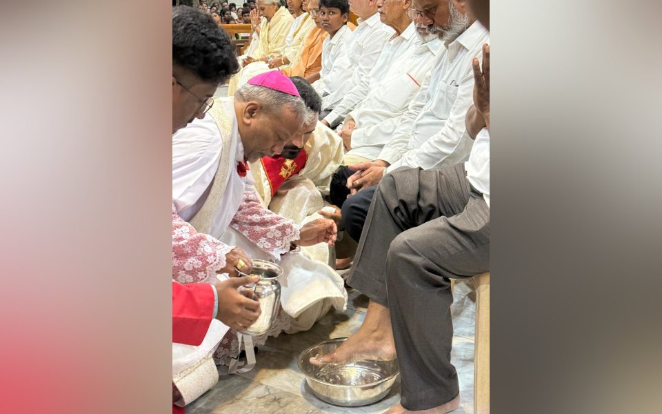 Archbishop Peter Machado reenacts washing of the feet on Maundy Thursday