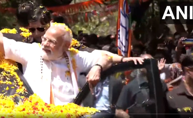PM Modi throws flower petals back at cheering crowd at road-show in poll-bound Karnataka
