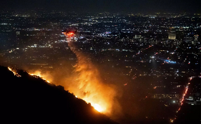 24 dead as fire crews try to corral Los Angeles blazes before winds return this week