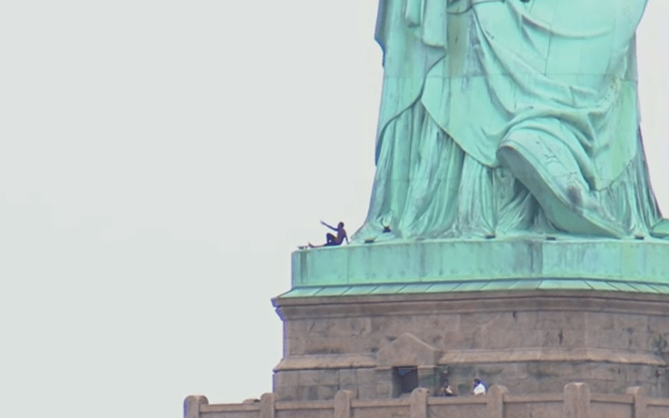 Woman climbs Statue of Liberty to protest family separations