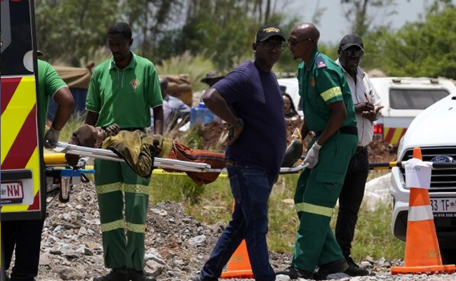 Dozens of survivors and dead pulled from abandoned South African mine as hundreds remain underground